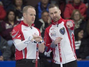 Newfoundland and Labrador skip Brad Gushue, right, and third Mark Nichols discuss a shot as they play Alberta at the Tim Hortons Brier curling championship at Mile One Centre in St. John's on Saturday, March 4, 2017.