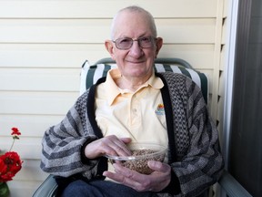 Dr. Al Slinkard holds a bowl of lentils at his home in Saskatoon.