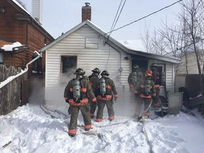 Members of the Saskatoon Fire Department extinguish a house fire in the 200 block of Avenue J South on March 7, 2017. (Saskatoon Fire Department)