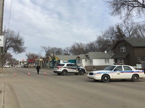 Members of the Saskatoon Police Service can be seen on 33rd Street as they look for a suspect after an officer was reportedly struck by what is believed to be a stolen vehicle on Tuesday afternoon. He was taken to hospital with serious, but non-life-threatening injuries, March 21, 2017. (Alex MacPherson/The Saskatoon StarPhoenix)