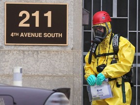 The hazardous materials unit recovers a suspicious package, a, powdery substance declared non-hazardous, from 211 4th Avenue South in Saskatoon on March 27, 2017. (Michelle Berg / Saskatoon StarPhoenix)