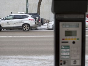 A City of Saskatoon Parking enforcement vehicle is seen near a pay station on February 20, 2016.