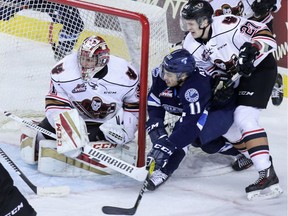 Calgary Hitmen goaltender Cody Porter stopped this Saskatoon Blades scoring chance by Arjun Atwal during WHL action at the Scotiabank Saddledome on Wednesday March 8, 2017. It was Porter's first game back after being injured in January. GAVIN YOUNG/POSTMEDIA NETWORK ORG XMIT: POS1703082130512666