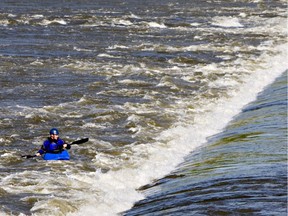 A kayaker enjoys whitewater conditions at the Saskatoon weir in June of 2011 when high water levels on the South Saskatchewan River created ideal conditions for thrill-seekers. (GORD WALDNER/The StarPhoenix)