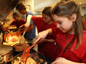 From right, Molly Richardson and Tiara Armstrong from Eastend, Saskatchewan cook ground beef for the taco dinner they're serving to families staying at the Ronald McDonald house in Saskatoon on March 14, 2017.