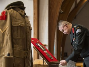 Malcolm Young sets out historical items related to the battle of Vimy Ridge during the First World War at Christ Church Anglican on Feb. 16, 2017.