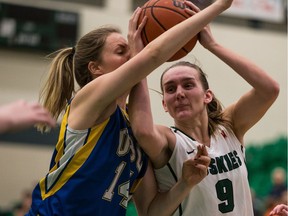University of Saskatchewan Huskies forward Megan Lindquist, right, battles for the ball with University of British Columbia Thunderbirds forward Susan Thompson in U Sports women's basketball action at the PAC.