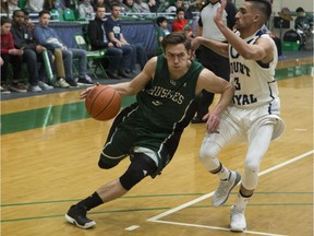 Huskie point guard Alex Unruh moves the ball around Mount Royal Charn Gill at the PAC Facility located on the University of Saskatchewan in Saskatoon on January 28, 2017. (Saskatoon StarPhoenix/Kayle Neis)