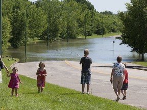 The Saskatoon environmental advisory committee has released a video reminding residents about the expected effects of climate change, like increased flooding. In this June 2013 photo, residents observe Spadina Crescent submerged under rising South Saskatchewan River waters. (GREG PENDER/The StarPhoenix)