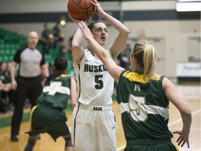 Huskies guard Sabine Dukate (5) goes to shoot the ball as Alberta guard Shay Crisp defends, (7) Maddie Rogers is seen behind at the PAC in Saskatoon, SK on Friday, March 3, 2017.