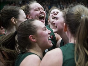 The University of Saskatchewan Huskies celebrate after winning the Canada West championship against the Regina Cougars at the PAC.