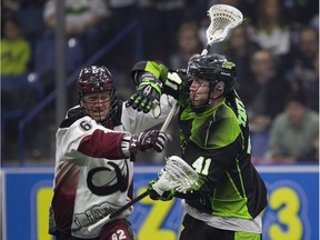 Rush forward Dan Taylor tangles with Colorado's Creighton Reid during recent NLL action.