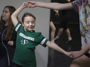 (L to R) Instructor Nicole Nienaber sits as Becca Spence and Jaymie Okell practice a traditional Irish dance at the River City School of Irish Dancers studio in Saskatoon, SK on March 15, 2017.
