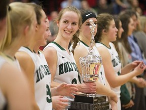 Players from Holy Cross High School basketball team celebrate after winning the city championship at Bedford Road Collegiate in Saskatoon on March 18, 2017.