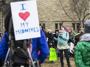 Fred Berry holds her child Blair while discussing her positive experience with a midwife if front of a crown of supporters outside the Royal University Hospital in Saskatoon, March 25, 2017.