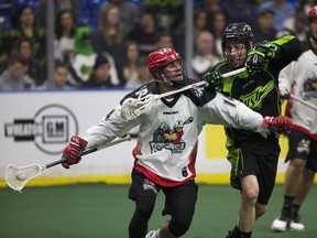 Saskatchewan defender Ryan Dilks puts the clamps on Calgary's Wesley Berg Friday night at SaskTel Centre.