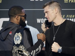 Tyron Woodley, left, and Stephen Thompson pose for photographers during a news conference for UFC 209, Thursday, March 2, 2017, in Las Vegas. The two are scheduled to fight in a welterweight championship mixed martial arts fight Saturday in Las Vegas. (AP Photo/John Locher)