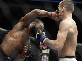 Tyron Woodley, left, hits Stephen Thompson in a welterweight championship mixed martial arts bout at UFC 209, Saturday, March 4, 2017, in Las Vegas.