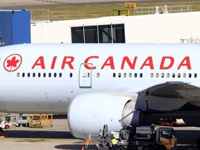 In this July 28, 2011 file photo, an Air Canada plane sits at a gate at the Sydney Airport in Sydney, Australia.