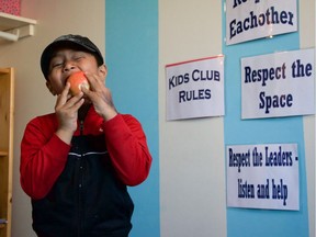 Afson Magar eating a healthy snack at Bread for Success, an after-school program for kids living in apartments along Appleby Drive in Saskatoon, Saskatchewan. Bread For Success provides individual academic support for youth, including homework assistance, cooking lessons, and gardening projects.     Bread for Success is one of the first two Canadian Global Family programs. The program rents an apartment building in Meadowgreen, dubbed the most diverse neighbourhood in Saskatoon. Many new immigrants and refugees as well as First Nations families settle here. (MCC photo/Meghan Mast)