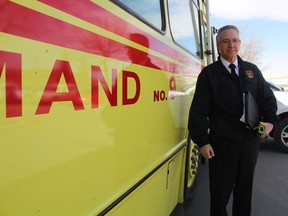 Assistant chief of communications with the Saskatoon Fire Department, Wayne Rodger, poses for a photo with the City of Saskatoon's current mobile command post at the scene of a suspicious package in the 2000 block of Airport Drive, April 6, 2017. Rodger says the rollout of an improved mobile command post will help improve emergency response, as the new vehicle will have more space and better technology features for emergency planning and response. (Morgan Modjeski/The Saskatoon StarPhoenix)