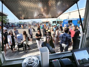 Eleven food trucks and hundreds of people populated the Sutherland Curling Rink parking lot on May 21, 2015 in Saskatoon as May Mayhem kicks off. The four day event is a food truck competition with local celebrity judges determining the best street dishes in the city.