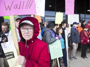 Carolyn Jones, foreground, carries a sign during a protest at the Saskatoon bus terminal on Thursday, April 13, 2017 against the provincial government's plan to close down the Saskatchewan Transportation Company (STC). (Saskatoon StarPhoenix/Kayle Neis)