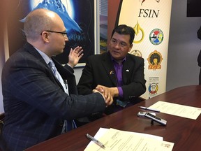 Elbow Mayor Rob Hundeby and FSIN Chief Bobby Cameron sign agreement to work on reconciliation.