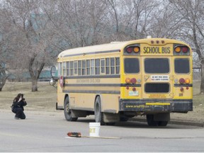 Prince Albert police investigators took pictures at the scene after an 82-year-old woman was struck by a school bus on April 27, 2017 while crossing an intersection at 10th Avenue West and 24th Street East