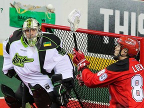 The Calgary Roughnecks' Riley Loewen catches a pass in front of the watchful eye of Saskatchewan Rush goalie Tyler Carlson during National Lacrosse League action in Calgary on Saturday April 29, 2017.