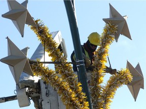 Workers with Saskatoon Light and Power work on a civic-owned Christmas decoration. A recent request from the city's downtown business improvement district may see the decorative lights on longer, as the city is examining how the request, which was heard at a recent city committee meeting, can be tied into Saskatoon's Winter City Strategy.