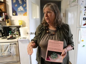 Jan Shadick, volunteer executive director at Living Sky Wildlife Rehabilitation, holds up a sign informing people to leave baby bunnies where they are, even if they are alone, because they are best cared for by their mom, in Saskatoon on April 24, 2017.