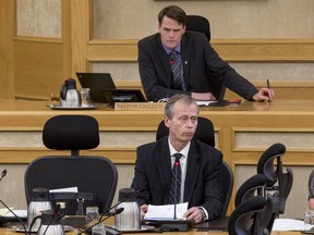 Saskatoon mayor Charlie Clark, top, listens as city manager Murray Totland speaks during a special city council meeting at city hall in Saskatoon, SK on Tuesday, April 4, 2017.