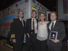 Scott Bell, right and David Piche, second in from left, where recognized by MD Ambulance for calling 911 and performing CPR to help save the life of Joanne Hildebrandt, second in from right, at the Badge, Shield & Star Dinner, stands for a photograph with MD Ambulance Deputy Chief Andrew Williamson following the event at Prairieland Park in Saskatoon, SK on Wednesday, April 12, 2017.