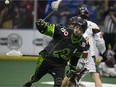 Saskatchewan Rush captain Chris Corbeil reaches for the ball as New England Black Wolves forward Chad Culp watches on during NLL action Saturday at SaskTel Centre.