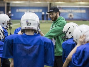 Ben Coakwell, Olympic bobsledder and ex-Huskies running back, leads drills during Saskatoon Minor Football's annual Playground to Pros football camp at SaskTel Sports Centre in Saskatoon, April 20, 2017.