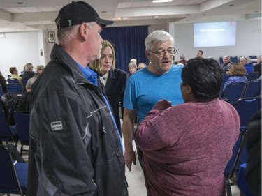 Candis Mclean, second from left, looks on as Lane Cooper, right (in blue), and a man who refused to give his name, ask Songgirl Reyes-Starr, a relative of Neil Stonechild, to leave the Army, Navy & Airforce Veterans building during a book signing by Mclean.