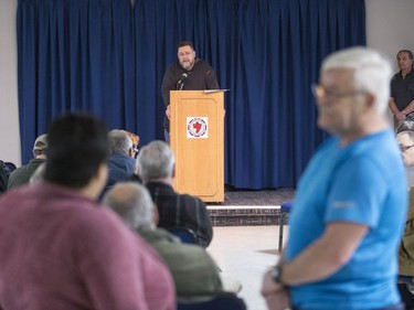 Stan Goertzen, former president of the Saskatoon City Police union, speaks as Lane Cooper, right, asks Songgirl Reyes-Starr, a relative of Neil Stonechild, to leave the Army, Navy & Airforce Veterans building during a book signing by Candis Mclean.