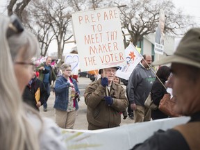 Larry Mullen carries a sign alongside fellow protesters outside a Premier's Dinner fundraiser for the Saskatchewan Party at Prairieland Park in Saskatoon on Thursday. Mullen said he has a daughter who is affected by the closure of the Saskatchewan Transportation Company and is worried about her job. April 27, 2017. (Saskatoon StarPhoenix/Kayle Neis)