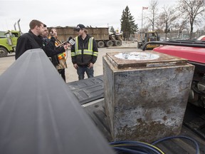 SASKATOON,SK--APRIL 27/2017-0428 web mystery safe- A safe that was discovered during the demolition of the former Bonanza restaurant sits in the back of the truck of Ryan Schwab,right, project co-ordinator with Z.C.T. Construction, as he speaks with media in Saskatoon, SK on Thursday, April 27, 2017. (Saskatoon StarPhoenix/Liam Richards)