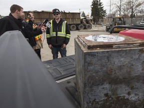 A safe that was discovered during the demolition of the former Bonanza restaurant sits in the back of the truck of Ryan Schwab,right, project co-ordinator with Z.C.T. Construction, as he speaks with media in Saskatoon, Sask. on Thursday, April 27, 2017.