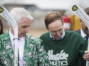 U of S president Peter Stoicheff (left), Merlis Belsher (center) stand behind the Field house as part of a ceremony to celebrate the construction of a new hockey rink at the U of S in Saskatoon, SK on Friday, April 28, 2017.