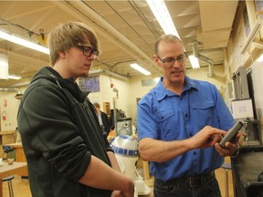 Todd Hiebert, the Industrial Arts teacher at Evan Hardy Collegiate, speaks with a student about the classroom's CNC Router, which was constructed by students in the classroom over the years, on March 29, 2017. His class is a place where student creativity takes shape and his students say they find value in constructing something with their own hands from start to finish. Learn more about the class in The Saskatoon StarPhoenix Inside The Classroom video feature at The Saskatoon StarPhoenix website. (Morgan Modjeski/The Saskatoon StarPhoenix)