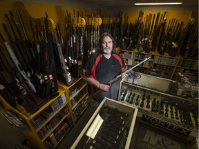 Michael Kincade, sales associate at North Pro Sports holds a rifle for a photograph in the store in Saskatoon, SK on Thursday, May 11, 2017. New firearms marking regulations coming into effect next month could drastically increase the price of firearms.