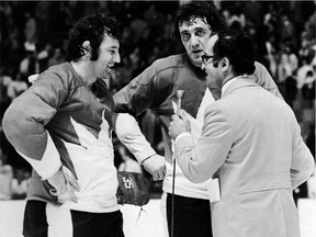 Johnny Esaw interviews Team Canada goaltender Tony Esposito (left) and his brother Phil after Canada's Game 2 win over Russia at the 1972 Summit Series in Toronto.