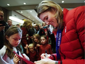 Team Canada women's hockey player and multiple Olympian Hayley Wickenheiser signs autographs after arriving home from the Sochi Olympics in Calgary, Alta., Tuesday, Feb. 25, 2014. Hayley Wickenheiser has retired from hockey after 23 years on Canada's women's team.The 38-year-old from Shaunavon, Sask., announced her retirement today.