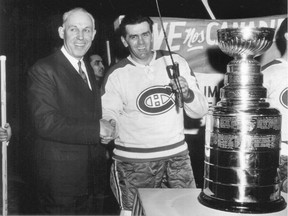 Clarence Campbell (left) presents the Stanley Cup to Maurice Richard in 1956, one year after the Richard Riot.