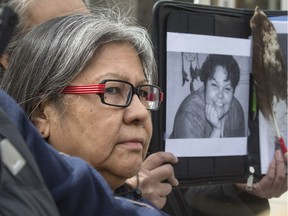 Elizabeth Fry Society's spokesperson speaking to the media at the Inquest into the death of Kinew James death at RPC with Kinew's mother Grace Campbell listening in with photos of Kinew being held up for the cameras in 2016.