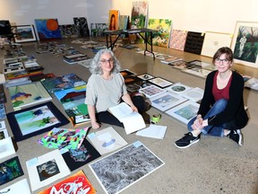 Mindy Yan Miller (left) and Jessica Morgun organize the art show All Together Now, an open-call community art show where professional artists and community members were invited to submit work, at aka artist-run.