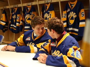 Blades draft picks Aidan De La Gorgendiere and Kyle Crnkovic chat with each other after trying on their new jersey in the Blades locker room at SaskTel Centre in Saskatoon on May 17, 2017.